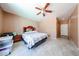 Simple bedroom with tile floors, ceiling fan, and basic furnishings at 10414 W Windsor Ave, Avondale, AZ 85392