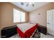 Warm bedroom with a ceiling fan, tile flooring, and natural light from the window at 10414 W Windsor Ave, Avondale, AZ 85392