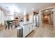 Open concept kitchen with island flowing into a dining area and living room with a cozy fireplace at 10414 W Windsor Ave, Avondale, AZ 85392