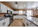 Spacious kitchen with granite counters, stainless steel appliances and island that flows into dining area at 10414 W Windsor Ave, Avondale, AZ 85392