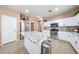 Kitchen featuring stainless steel appliances, white cabinets, granite countertops, and a large island at 10414 W Windsor Ave, Avondale, AZ 85392