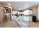 Bright kitchen with white cabinets, granite countertops, stainless steel appliances and lots of natural light at 10414 W Windsor Ave, Avondale, AZ 85392