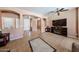 Open-concept living space with tile floors, arched doorways, and a media center at 10414 W Windsor Ave, Avondale, AZ 85392