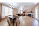 Open-concept dining and living area, with large windows, tile flooring, and cozy fireplace at 10414 W Windsor Ave, Avondale, AZ 85392