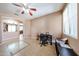 Bright room featuring tile flooring, a ceiling fan, and a home office at 10414 W Windsor Ave, Avondale, AZ 85392