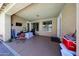 Covered patio featuring a ceiling fan, TV, and outdoor access for relaxation and entertainment at 10414 W Windsor Ave, Avondale, AZ 85392