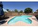 Backyard view featuring a refreshing private pool surrounded by brick pavers and mature landscaping at 10414 W Windsor Ave, Avondale, AZ 85392