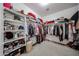 Bright walk-in closet with built-in shelving and hanging rods provides optimal storage solutions at 10414 W Windsor Ave, Avondale, AZ 85392