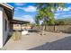 View of the covered patio area in a well-maintained backyard, offering an ideal spot for outdoor activities at 1119 W Ellis Dr, Tempe, AZ 85282