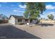 The backyard showcases a neutral-toned design and mature tree, providing a serene and private outdoor space at 1119 W Ellis Dr, Tempe, AZ 85282
