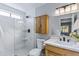 Modern bathroom featuring a glass-enclosed shower, sleek fixtures, and wood-look vanity at 1119 W Ellis Dr, Tempe, AZ 85282