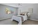 Cozy bedroom with a plush bed, neutral decor, and a bright window overlooking the yard at 1119 W Ellis Dr, Tempe, AZ 85282