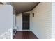 Covered entryway with a decorative security door, brick facade and tiled landing at 1119 W Ellis Dr, Tempe, AZ 85282