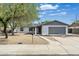 Charming single-story home with a gray roof, a gray garage door and xeriscaping at 1119 W Ellis Dr, Tempe, AZ 85282