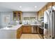 Well-lit kitchen features stainless steel appliances, white countertops, and natural wood cabinetry at 1119 W Ellis Dr, Tempe, AZ 85282