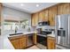 Well-equipped kitchen with stainless steel appliances, custom cabinets, and white countertops at 1119 W Ellis Dr, Tempe, AZ 85282