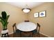 Well-lit dining room features a modern light fixture and seats four at 11375 E Sahuaro Dr # 1055, Scottsdale, AZ 85259