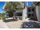 Condo exterior with a walkway, stairs to the second level, xeriscaping, and flowering trees at 11375 E Sahuaro Dr # 1055, Scottsdale, AZ 85259