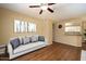 Cozy living room with wood floors, ceiling fan, view to the kitchen, and modern décor at 11375 E Sahuaro Dr # 1055, Scottsdale, AZ 85259