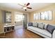 Comfortable living room featuring wood floors, ceiling fan, and sliding doors to the patio at 11375 E Sahuaro Dr # 1055, Scottsdale, AZ 85259