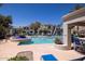 Resort-style pool area featuring a beautiful fountain, comfortable lounge chairs, and lush landscaping at 11375 E Sahuaro Dr # 1055, Scottsdale, AZ 85259
