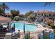 Community pool with lounge seating, dining, and shade for relaxation and socializing at 11375 E Sahuaro Dr # 1055, Scottsdale, AZ 85259