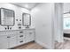 Modern bathroom featuring double sinks, new fixtures, and wood flooring at 120 E Rio Salado Pkwy # 101, Tempe, AZ 85281