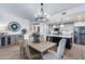Dining area with modern chandelier, wood table, and views into a kitchen with an island and stainless steel appliances at 120 E Rio Salado Pkwy # 101, Tempe, AZ 85281