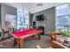 Inviting game room with a vibrant red pool table, cozy seating, and a flatscreen TV at 120 E Rio Salado Pkwy # 101, Tempe, AZ 85281