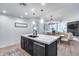 Stylish kitchen island with quartz countertop, black base, stainless steel appliances, and open layout to the living area at 120 E Rio Salado Pkwy # 101, Tempe, AZ 85281