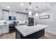 Bright kitchen with quartz countertops, white cabinetry, stainless steel appliances, and modern pendant lighting at 120 E Rio Salado Pkwy # 101, Tempe, AZ 85281