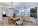 Open living space featuring a dining table, fireplace, and a view to the outdoor terrace through expansive windows at 120 E Rio Salado Pkwy # 101, Tempe, AZ 85281