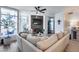 Bright living room features a fireplace, ceiling fan, large windows, and connects to the dining and kitchen areas at 120 E Rio Salado Pkwy # 101, Tempe, AZ 85281
