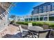 Relaxing patio area with brick flooring, a table with chairs, landscaping, and a building in the background at 120 E Rio Salado Pkwy # 101, Tempe, AZ 85281
