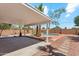 Covered backyard patio with a concrete slab leading to a refreshing pool surrounded by landscaping at 1238 E Cambridge Ave, Phoenix, AZ 85006
