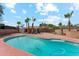 Large backyard pool with red brick trim with lush landscaping and clear blue sky in the background at 1238 E Cambridge Ave, Phoenix, AZ 85006