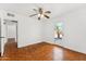 Bedroom with parquet floors, ceiling fan, and door to backyard at 1238 E Cambridge Ave, Phoenix, AZ 85006