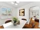 Bright dining room features white walls, modern table, and an arched doorway to the living area at 1238 E Cambridge Ave, Phoenix, AZ 85006
