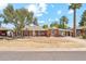 Charming brick home with mature landscaping, carport, and driveway viewed from street at 1238 E Cambridge Ave, Phoenix, AZ 85006