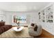 Staged living room with stylish furniture, a large window, and built-in shelving at 1238 E Cambridge Ave, Phoenix, AZ 85006