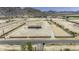 Expansive horse property featuring a central house and fenced riding area set against a mountain backdrop at 13050 N Breeze Way, Maricopa, AZ 85139