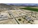 Overhead view of a horse property, showcasing the layout with green fields and mountain views at 13050 N Breeze Way, Maricopa, AZ 85139