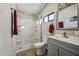 Nicely updated bathroom with step-in shower, gray vanity and wood-look tile floors at 13050 N Breeze Way, Maricopa, AZ 85139