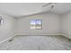 A neutral bedroom featuring wood-look tile flooring and a large window view at 13050 N Breeze Way, Maricopa, AZ 85139