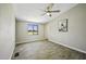 Bright bedroom with wood-look floors, ceiling fan, and natural light at 13050 N Breeze Way, Maricopa, AZ 85139