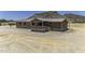 A charming home with a covered front porch and desert landscape at 13050 N Breeze Way, Maricopa, AZ 85139