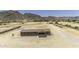 Exterior angle of home showcasing mountain views, and a large, fenced dirt lot at 13050 N Breeze Way, Maricopa, AZ 85139