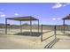 Equestrian property featuring shelters and corrals set against a serene desert landscape at 13050 N Breeze Way, Maricopa, AZ 85139