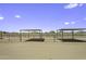 Horse stalls on a dirt lot, with metal roofing and fencing at 13050 N Breeze Way, Maricopa, AZ 85139