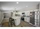 Beautifully updated kitchen with white cabinets, stainless appliances, and quartz counters, all open to the living area at 13050 N Breeze Way, Maricopa, AZ 85139